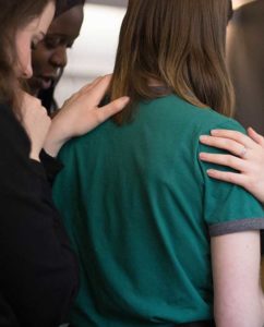 Image of some young women comforting another woman. This image is a link to the "How To Support" page.
